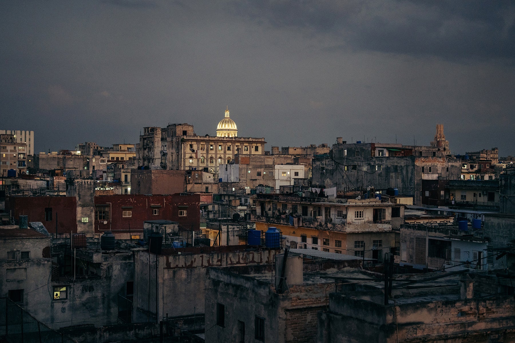 Color art print of Cuban cityscape at dusk. 