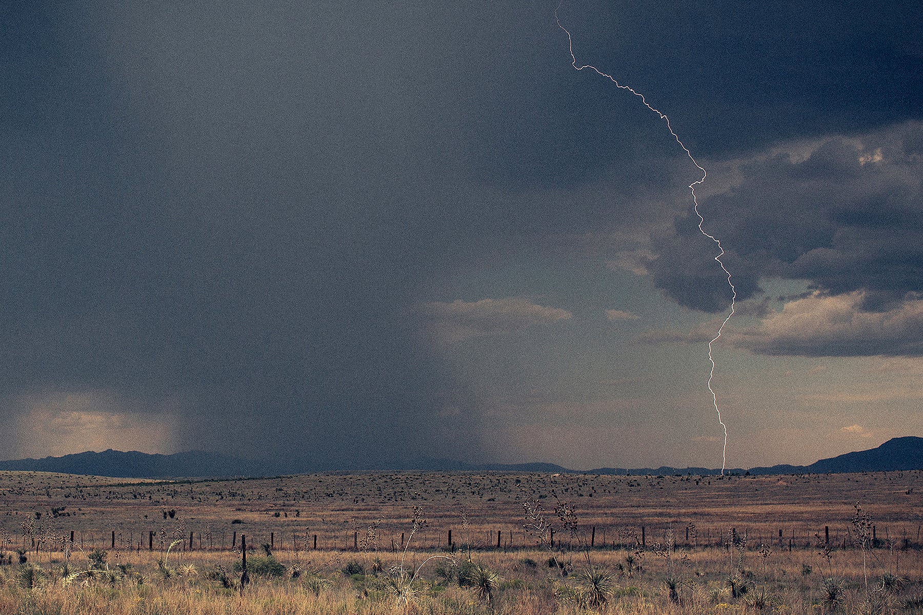 Fine art print of a lightning bolt striking the countryside near a ranch in Marfa, Texas.