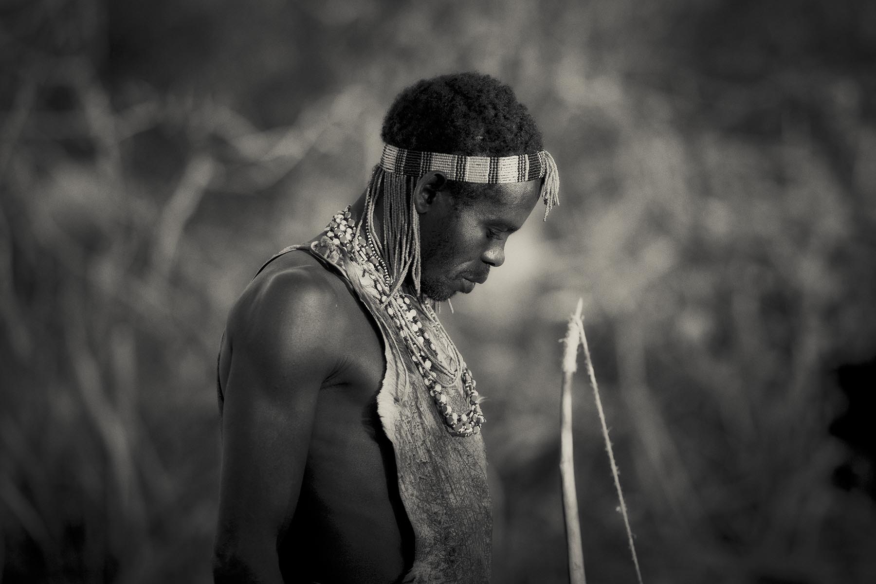 Black and white fine art print of a person wearing traditional attire with a blurred natural background
