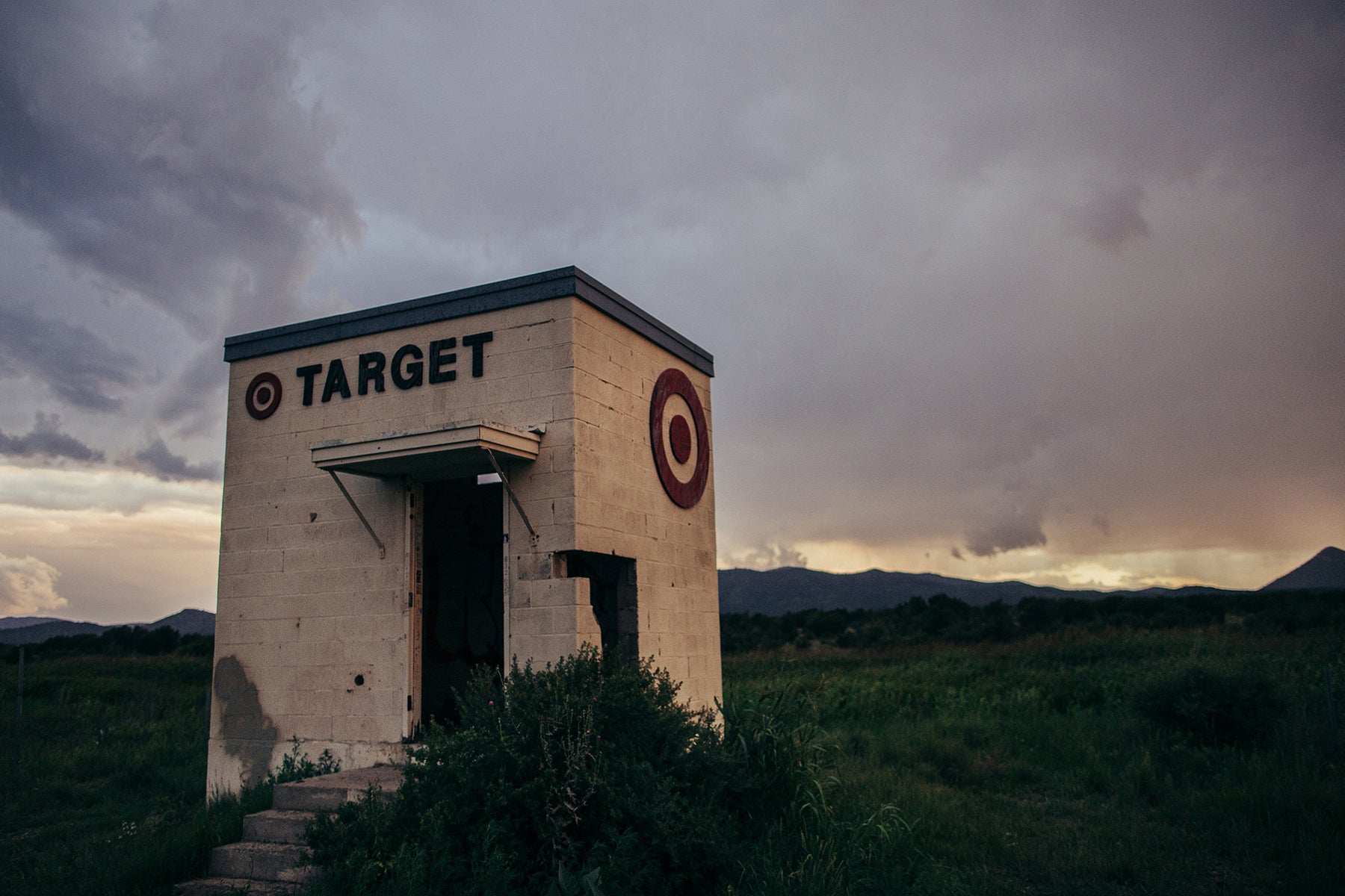 Cinderblock white structure in the countryside of Marathon Texas with a Target sign on top.